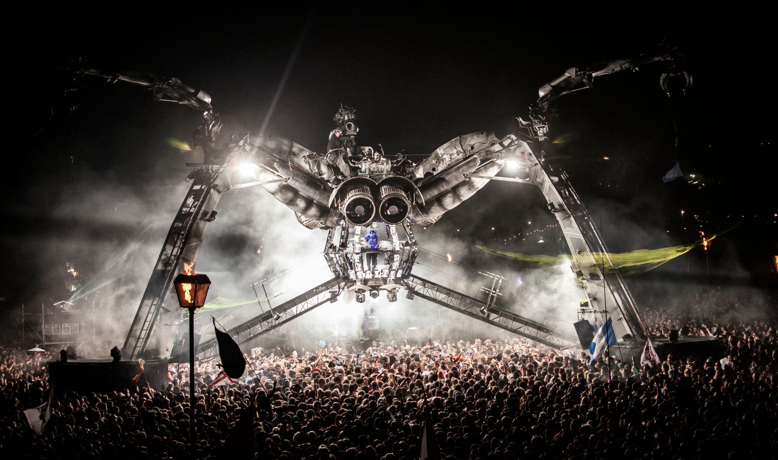 Festival crowd in front of a lit stage after dark