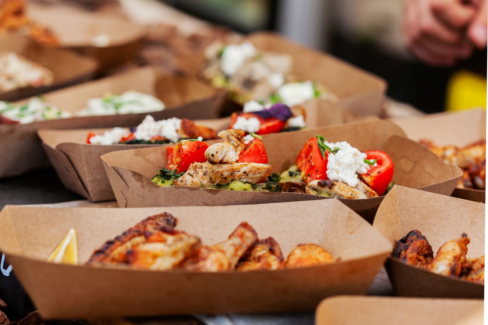 Grilled chicken, feta and wings served in kraft food trays